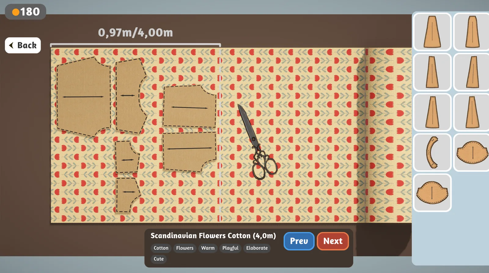 Cutting table with pattern pieces laid out on printed cotton
